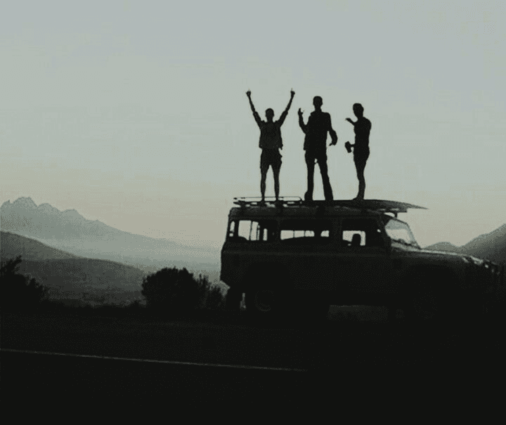 Travellers on a van at dusk